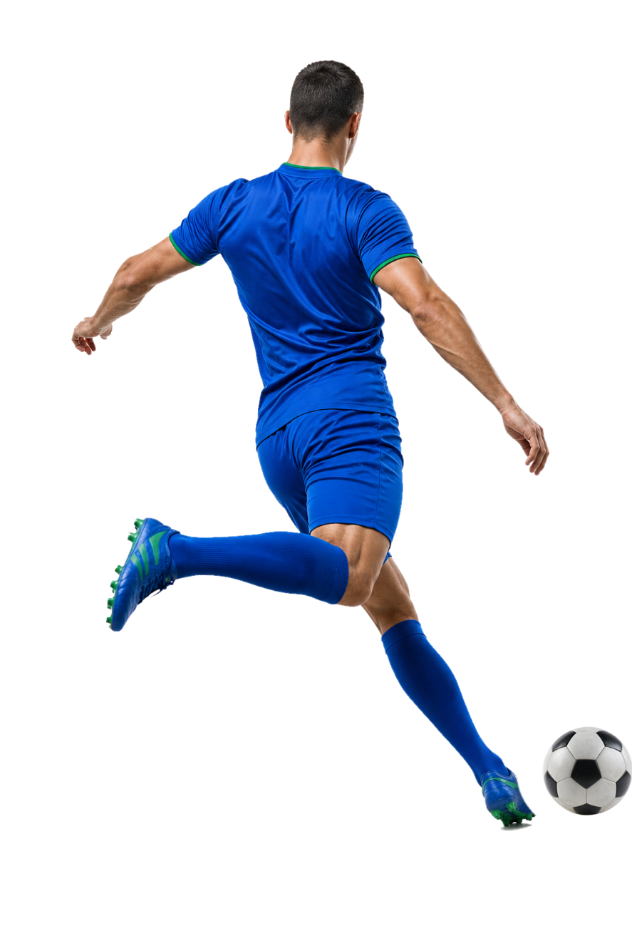 Footballer striking a ball on a sunlit pitch